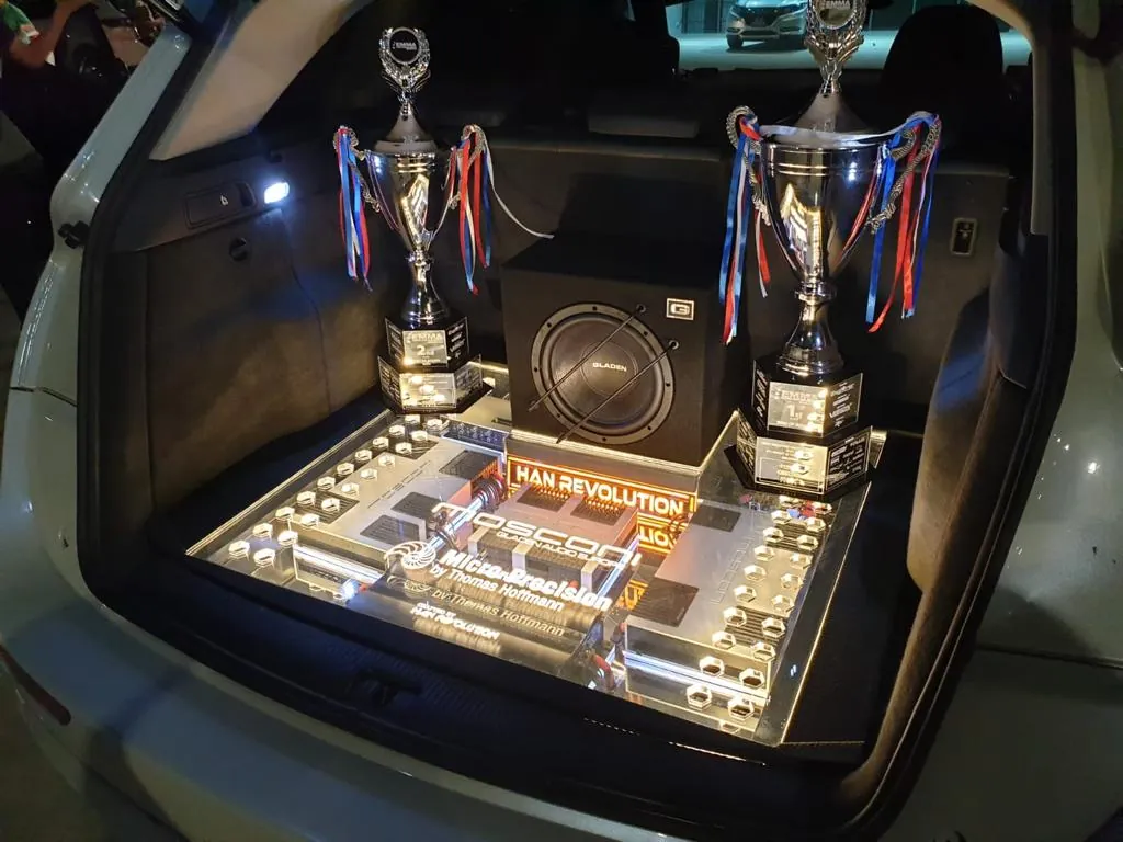 Han Revolution EMMA King of Sound championship-winning car audio install, with the competition trophies displayed in the boot