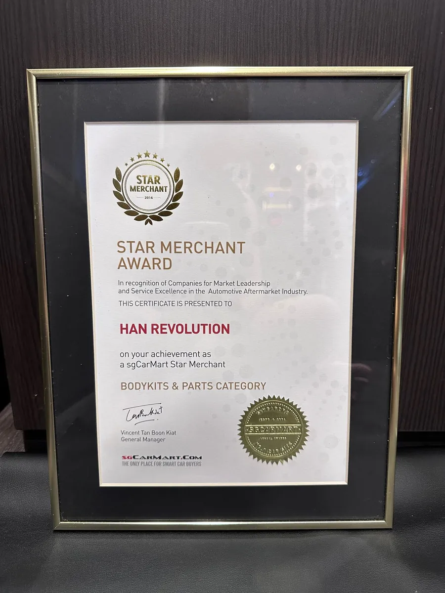 Framed sgCarMart Star Merchant certificate awarded to Han Revolution