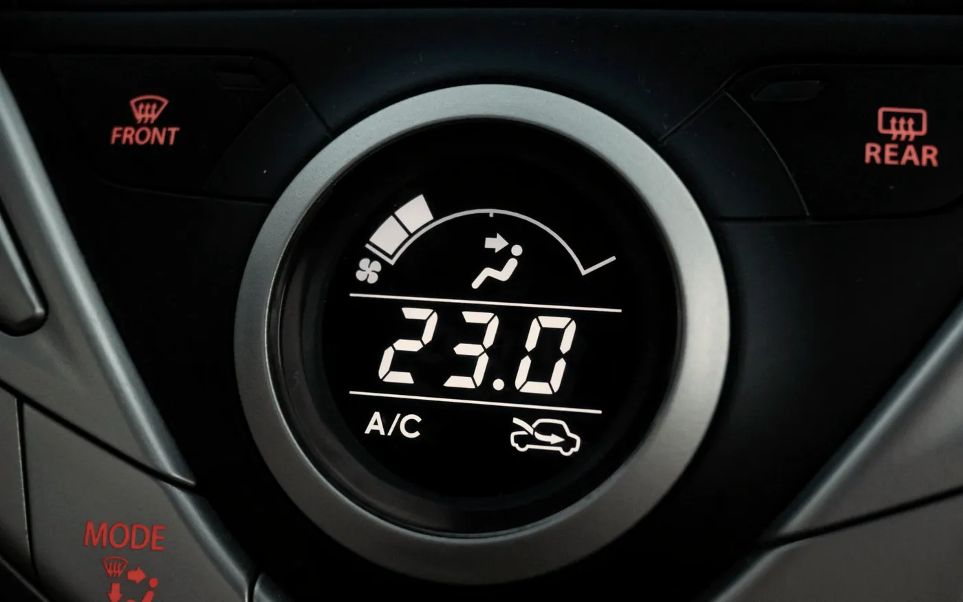 Car climate control dial set to 23 degrees with the A/C engaged