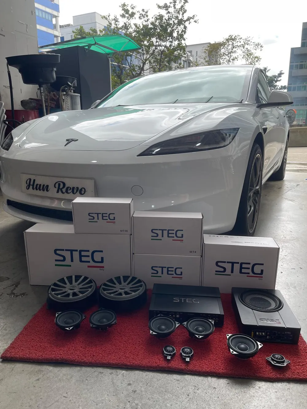White Tesla with STEG Italy speaker boxes ready for an audio upgrade at Han Revolution