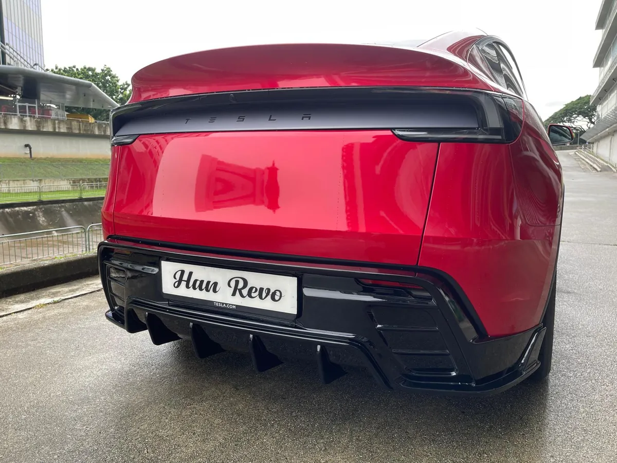 Rear diffuser of the Han Revolution rev 1 bodykit on a red Tesla Model Y Juniper