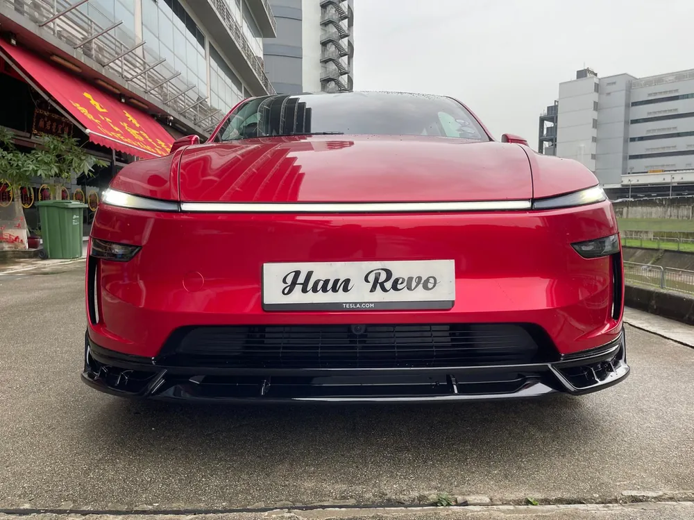 Front lip of the Han Revolution rev 1 bodykit on a red Model Y Juniper