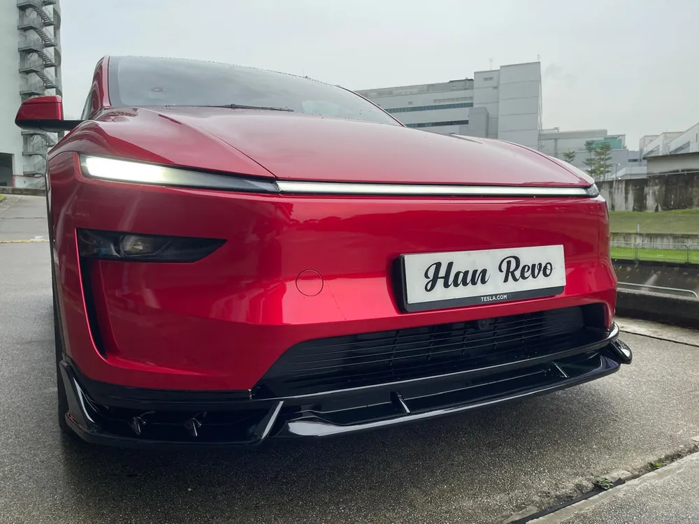 Front three-quarter view of a red Tesla Model Y Juniper with the Han Revolution bodykit