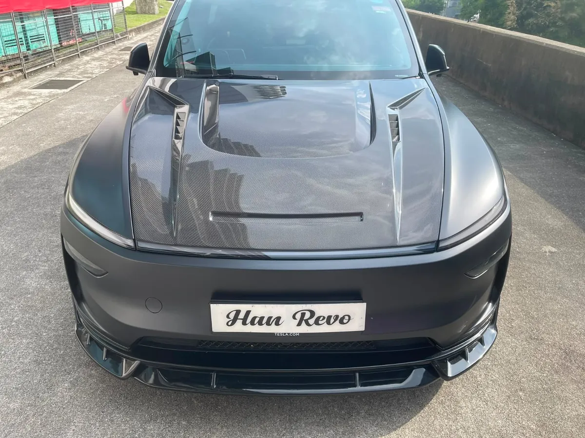 Front view of a Tesla Model Y Juniper fitted with a vented carbon fibre bonnet by Han Revolution