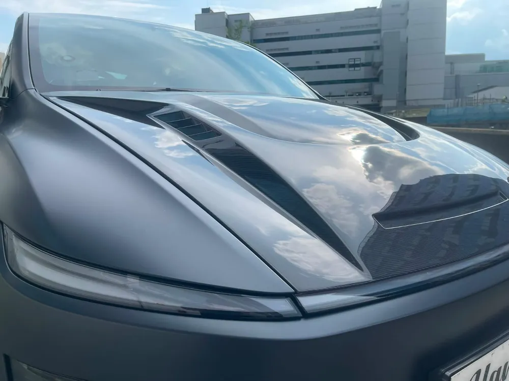 Close-up of the vents on a carbon fibre Tesla Model Y Juniper bonnet