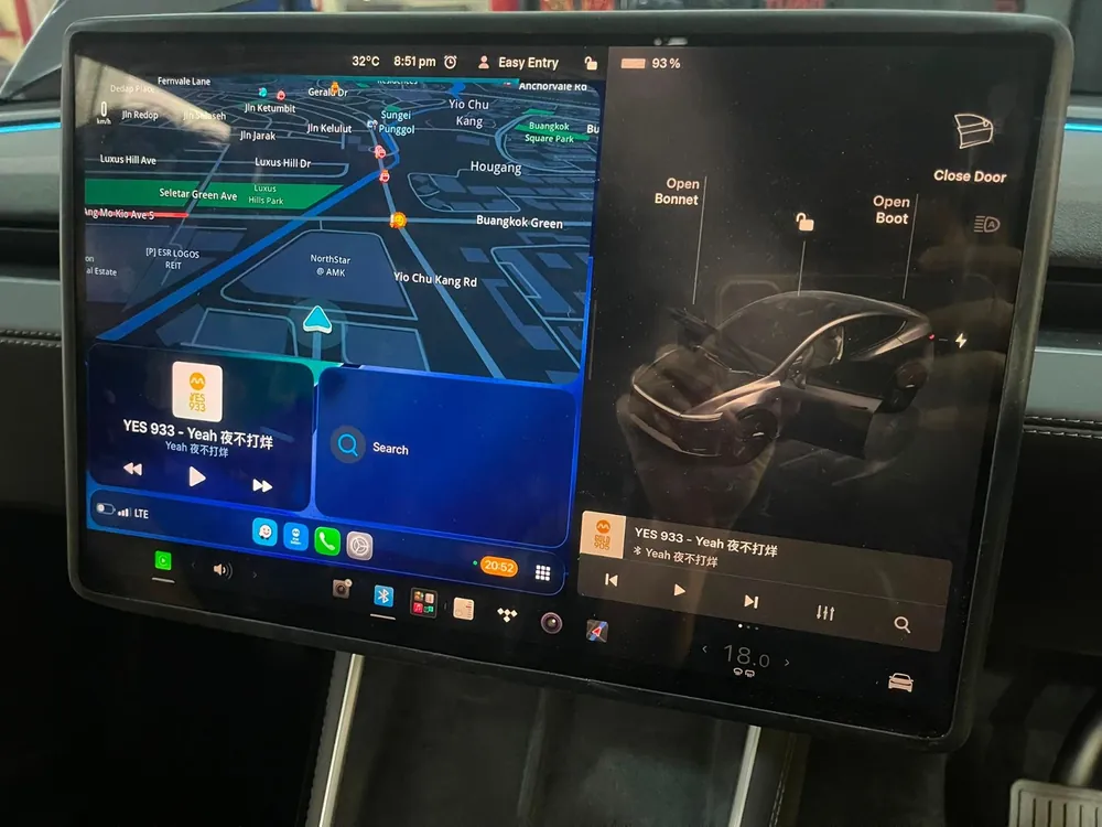 Tesla touchscreen showing CarPlay navigation and music together, installed by Han Revolution