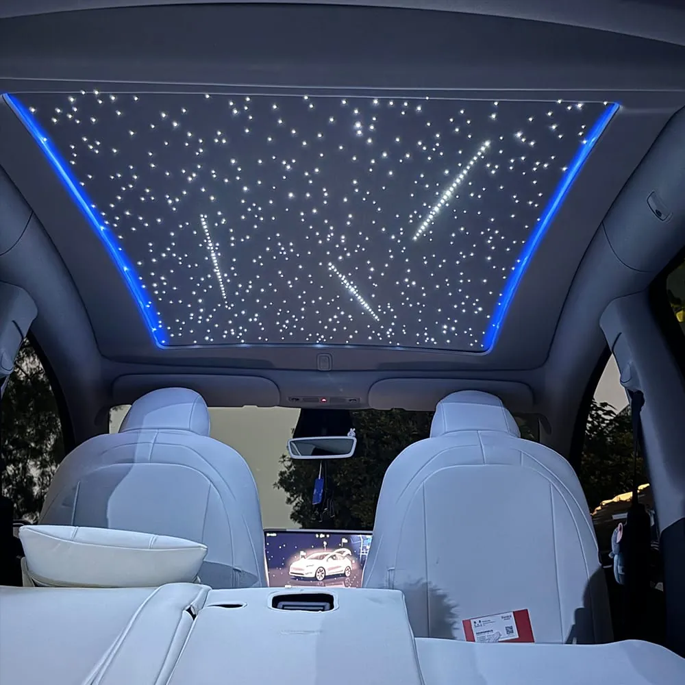 Tesla starlight roof shade lit in blue, viewed from the rear seats